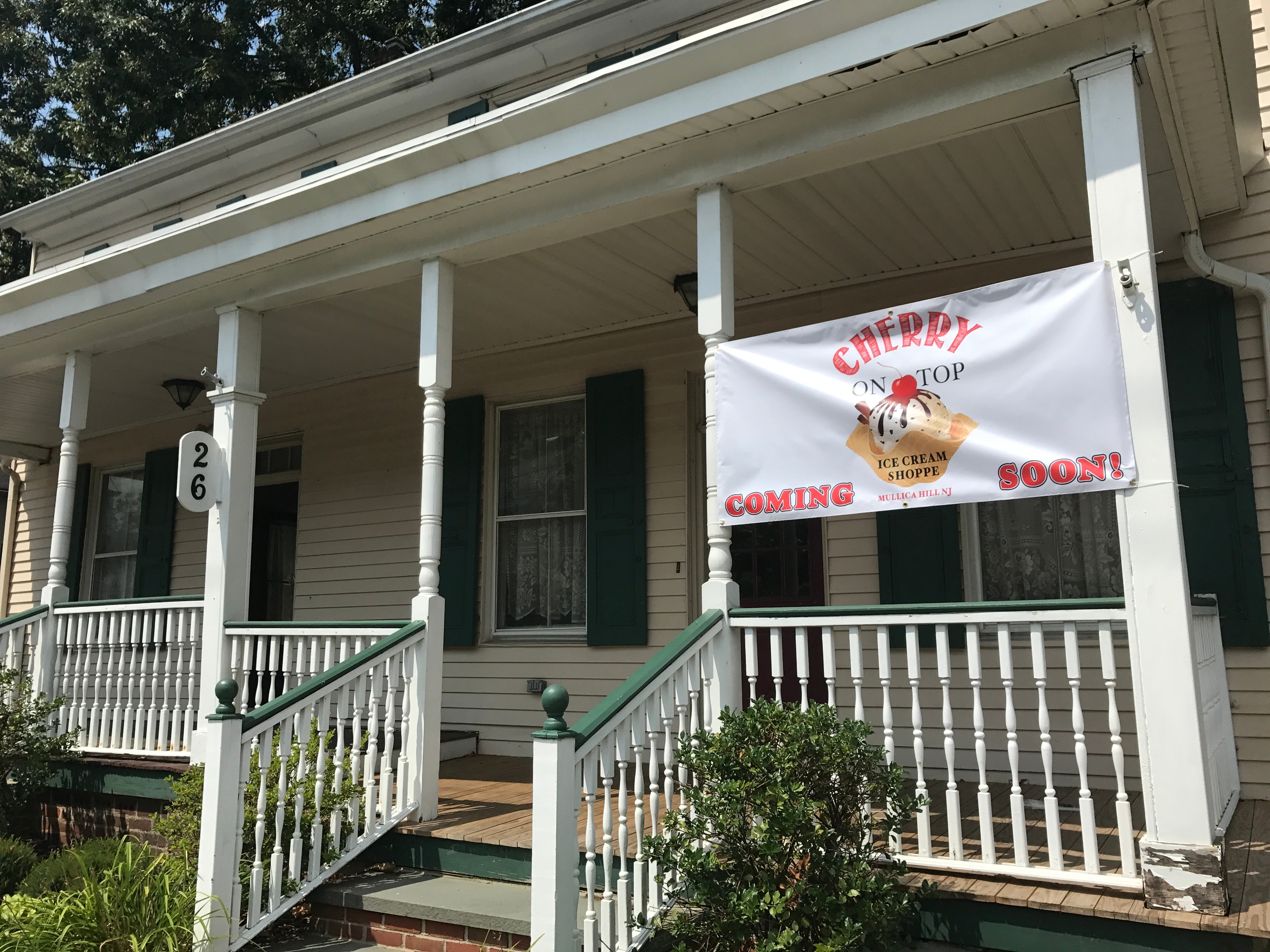The historic house at 26 S Main St wearing its 'Coming Soon' banner, summer 2017