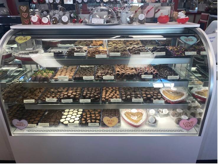 The chocolate case stocked with turtles, barks, and Valentine hearts